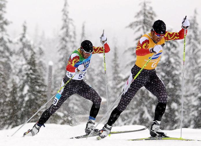 Two male Para cross-country skiing athletes in action